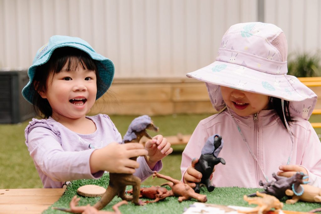 Children playing with dinosaur toys and engaging in imaginative play